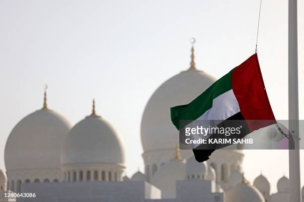 The flag of United Arab Emirates flies at half-mast outside the Sheikh Zayed Grand Mosque in Abu Dhabi on May 13 following the death of UAE's...