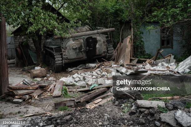 The remains of a military vehicle is seen following the shelling of the village of Bilogorivka, Lugansk region, eastern Ukraine, pictured on May 13,...