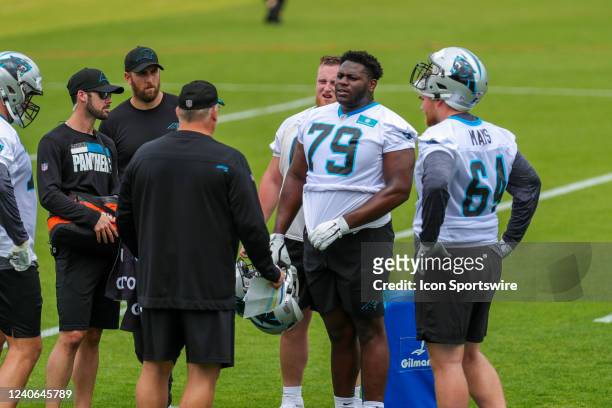 Carolina Panthers Tackle Ikem Ekwonu and Offensive Line Cade Mays talk to a coach during a water break during day one of the Rookie Mini Camp on May...