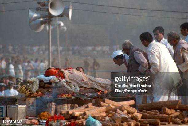 Indira Gandhi's son, Rajiv Gandhi lighting the funeral pyre for the slain Indian Prime Minister during the cremation ceremony 3rd November, 1984 at...