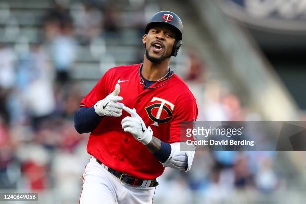 Byron Buxton of the Minnesota Twins celebrates his solo home run as he rounds the bases against the Cleveland Guardians in the first inning of the...