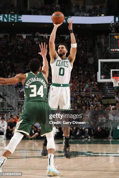 Jayson Tatum of the Boston Celtics shoots a three point basket during the game against the Milwaukee Bucks during Game 6 of the 2022 NBA Playoffs...