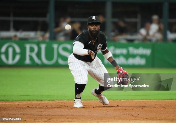 Chicago White Sox second baseman Josh Harrison flicks the ball to second base for one out during a Major League Baseball game between the New York...