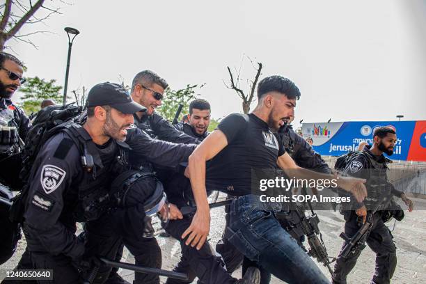 Israeli police officers push and kick a Palestinian youth during Shireen Abu Akleh's funeral procession. Al Jazeera journalist Shireen Abu Akleh was...