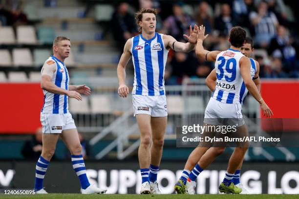Nick Larkey of the Kangaroos celebrates a goal with Flynn Perez of the Kangaroos during the 2022 AFL Round 09 match between the North Melbourne...