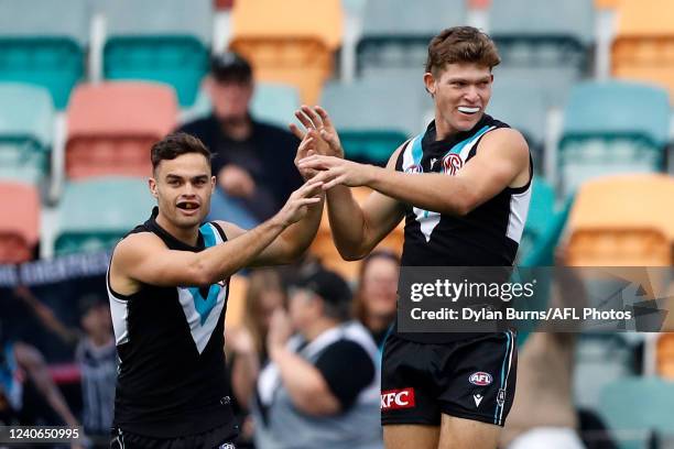 Mitch Georgiades of the Power celebrates a goal with Karl Amon of the Power during the 2022 AFL Round 09 match between the North Melbourne Kangaroos...