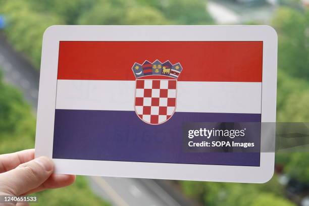 In this photo illustration, the Croatian flag is printed on a white card.