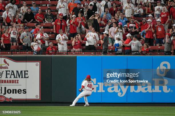 St. Louis Cardinals center fielder Harrison Bader watches as the ball sails over the fence for a home run into the crowd during a game between the...