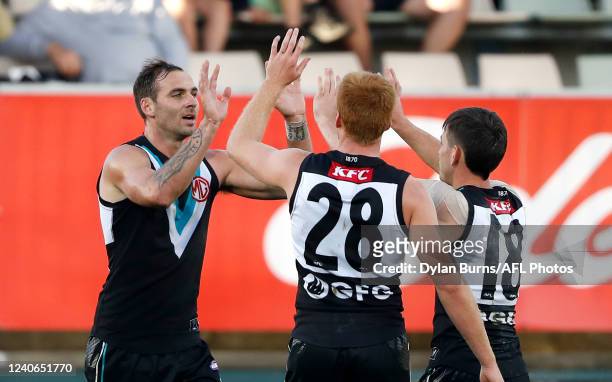 Jeremy Finlayson of the Power celebrates a goal with teammates during the 2022 AFL Round 09 match between the North Melbourne Kangaroos and the Port...