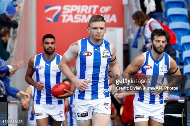 Jack Ziebell of the Kangaroos leads his team on to the ground during the 2022 AFL Round 09 match between the North Melbourne Kangaroos and the Port...