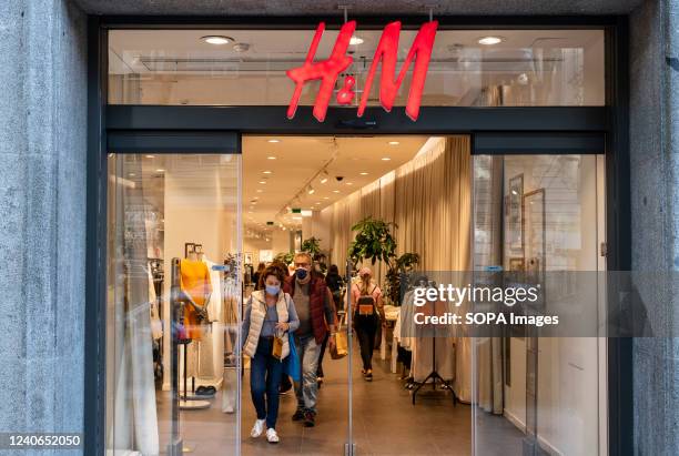 Shoppers are seen at the Swedish multinational clothing design retail company Hennes & Mauritz, H&M, store.