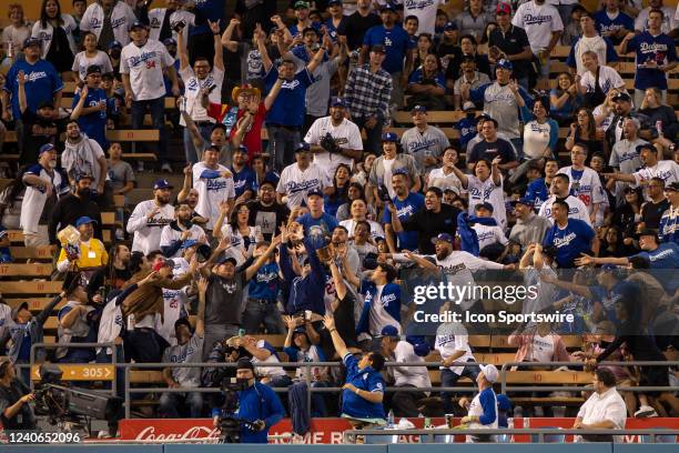 Fans attempt to catch a 3rd inning home run by Los Angeles Dodgers left fielder Chris Taylor during a regular season game between the Los Angeles...