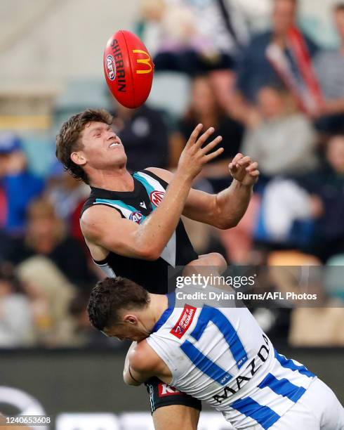 Mitch Georgiades of the Power is tackled by Lachie Young of the Kangaroos during the 2022 AFL Round 09 match between the North Melbourne Kangaroos...