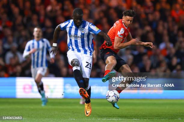 Mouhamadou-Naby Sarr of Huddersfield Town and Harry Cornick of Luton Town during the Sky Bet Championship Play-off Semi Final 1st Leg match between...