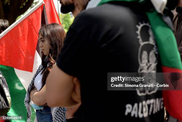 Young people with Kefiah and Palestinian flag demonstrate in front of the Leonardo SPA headquarters in solidarity with the Palestinian people against...