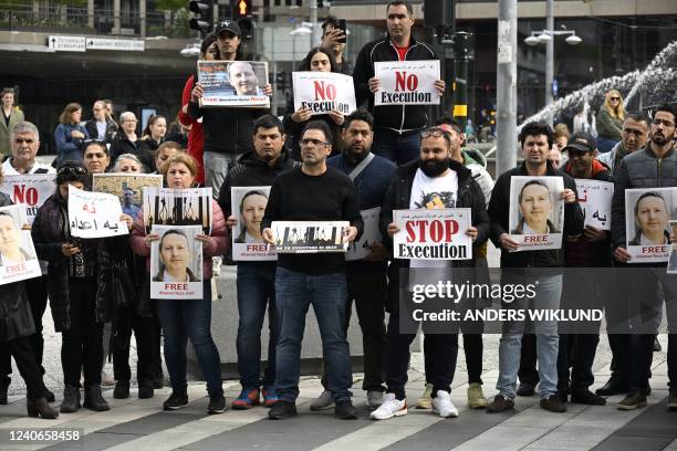 Demonstrators hold posters with a portrait of Swedish-Iranian doctor and researcher Ahmadreza Djalali who is imprisoned and sentenced to death in...