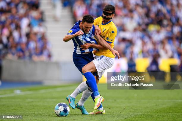 Joao Mario of FC Porto and Rui Fonte of Estoril Praia in action during the Liga Portugal Bwin match between FC Porto and GD Estoril Praia at Estadio...