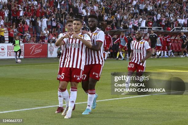 Ajaccio's French Midfielder Riad Nouri is congratulated by teammates after scoring a goal during the last L2 football match for the 2022 season...