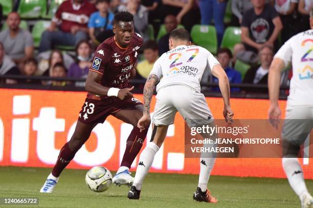 Metzs Bissau-Guinean defender Fali Cande fights for the ball with Angers French midfielder Mathias Pereira Lage during the French L1 football match...