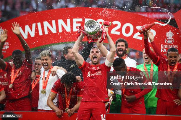 Jordan Henderson of Liverpool holds the trophy aloft following his sides victory in a penalty shootout during The FA Cup Final match between Chelsea...