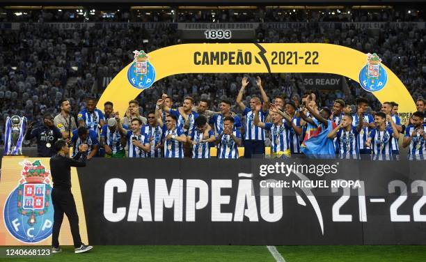 Porto's players celebrate with the Primeira Liga trophy after winning the Portuguese league football match between FC Porto and GD Estoril Praia at...
