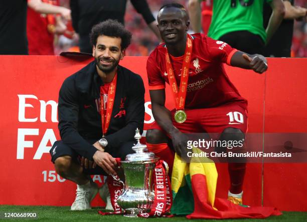 Mohamed Salah and Sadio Mane of Liverpool pose with the trophy following their sides victory in a penalty shootout during The FA Cup Final match...