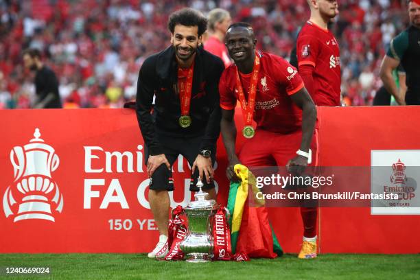 Mohamed Salah and Sadio Mane of Liverpool pose with the trophy following their sides victory in a penalty shootout during The FA Cup Final match...