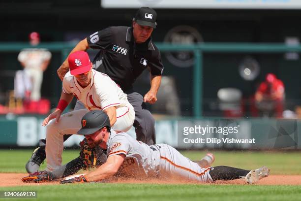Donovan Walton of the San Francisco Giants slides safely into second base with a double against Tommy Edman os the St. Louis Cardinals as umpire Phil...