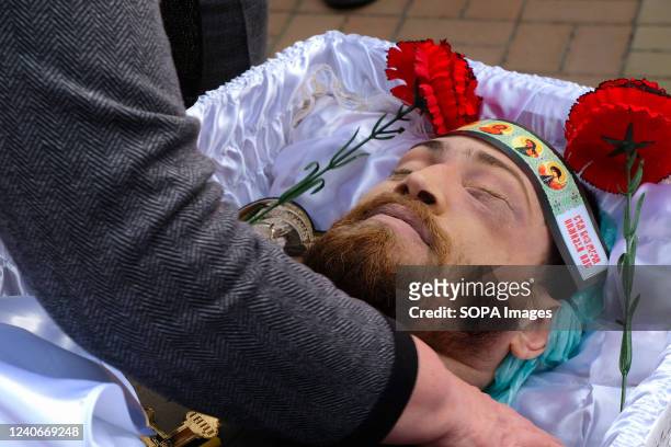 The body of Sergey Titov, 32 years old, sergeant of the National Guard, killed by a Russian shelling attack in Orikhiv, is seen during his burial at...