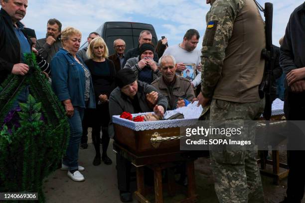Parents pay their respects to their son Sergey Titov, 32 years old, sergeant of the National Guard, killed by a Russsian shelling in Balabyne...