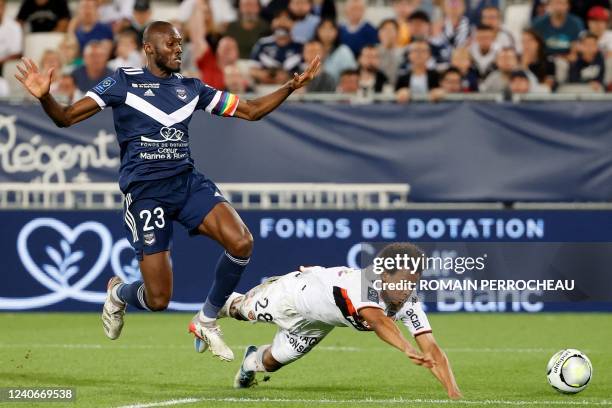 Bordeaux' French midfielder Joshua Guilavogui and Lorient' French forward Armand Lauriente battle for the ball during the French L1 football match...