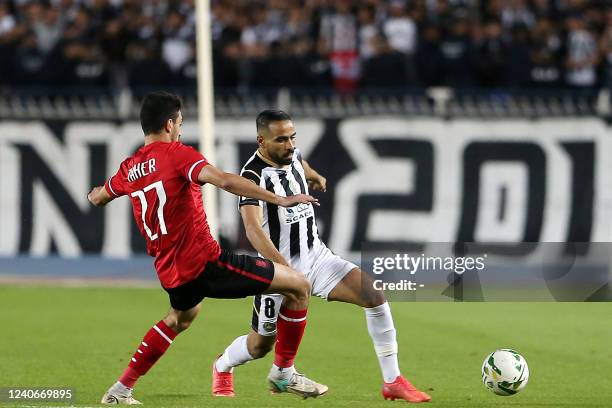 Ahly's forward Taher Mohamed and Setif's defender Houari Ferhani vie for the ball during the CAF Champions League Semi-Final between Algeria's ES...