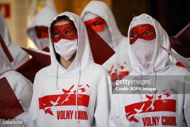 The Belarusian Free Choir perform while hiding faces for security reasons at the St. Alexander's Church in Warsaw during the Pray for Ukraine event...