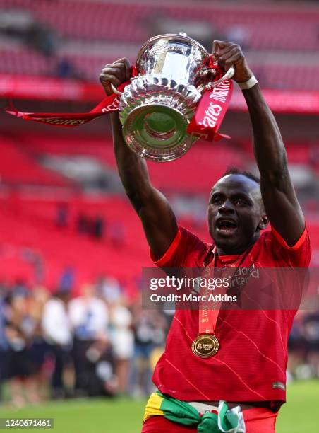 Sadio Mane of Liverpool celebrates with the Emirates FA Cup trophy following his team's victory in The FA Cup Final match between Chelsea and...