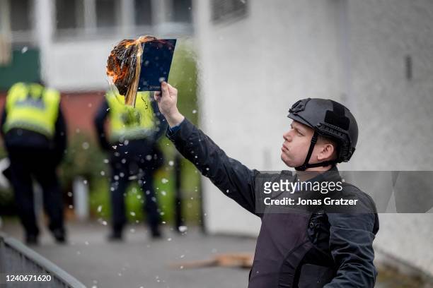 Rasmus Paludan burns a Koran during an election meeting in Husby on May 14, 2022 in Stockholm, Sweden. Far-right Danis-Swedish politican Rasmus...