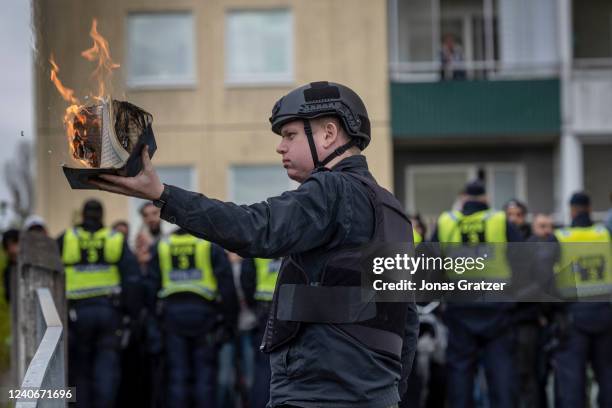 Rasmus Paludan burns a Koran during an election meeting in Husby on May 14, 2022 in Stockholm, Sweden. Far-right Danis-Swedish politican Rasmus...