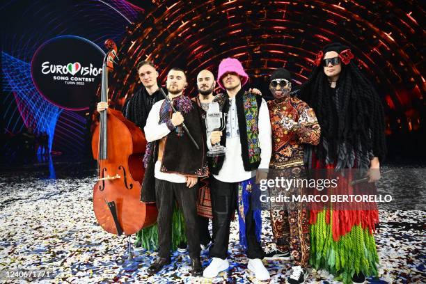 Members of the band "Kalush Orchestra" pose onstage with the winner's trophy and Ukraine's flags after winning on behalf of Ukraine the Eurovision...