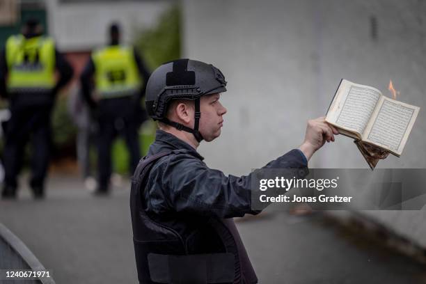 Rasmus Paludan burns a Koran during an election meeting in Husby on May 14, 2022 in Stockholm, Sweden. Far-right Danis-Swedish politican Rasmus...