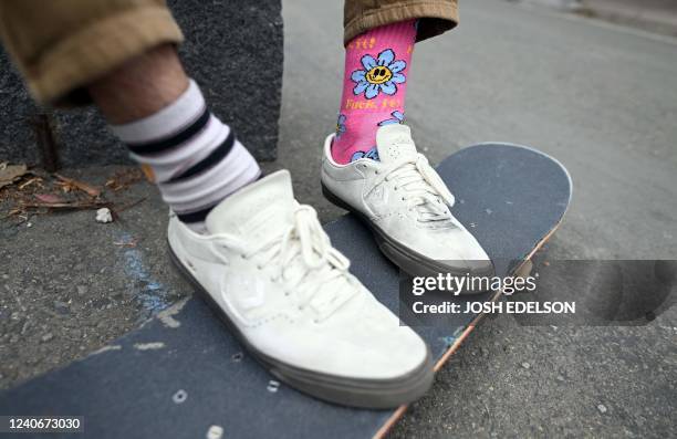 Dexter Lotz wears mismatched socks while sitting with Zion Ricks-Gaines at a skateboard park in San Francisco, California on May 6, 2022. - Getting...