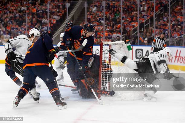 Ryan McLeod and goaltender Mike Smith of the Edmonton Oilers defend Carl Grundstrom of the Los Angeles Kings during the first period in Game Seven of...