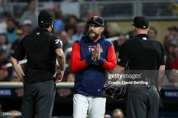 Rocco Baldelli of the Minnesota Twins argues with umpires John Tumpane and Ryan Blakney after getting ejected for arguing a baserunner obstruction...