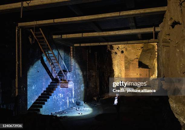 April 2022, North Rhine-Westphalia, Porta Westfalica: A man walks through a partially collapsed gallery in the Jakobsberg near Porta Westfalica. The...