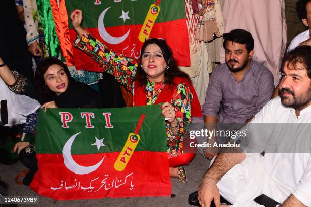 Supporters of Pakistan Tehreek-e-Insaf Imran Khan holding party flags as they take part in a protest against crackdown and shelling against the...