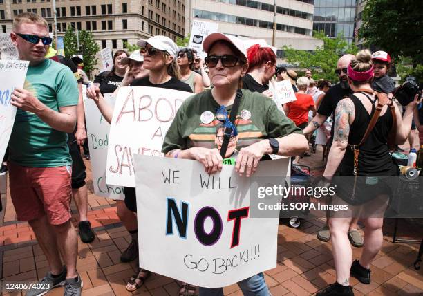 Protester holds a placard expressing his opinion at a pro abortion rights rally. People from many different cities gathered to support and rally for...