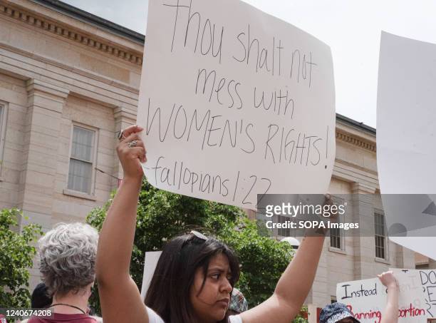 Protester holds a placard expressing her opinion at a pro abortion rights rally. People from many different cities gathered to support and rally for...