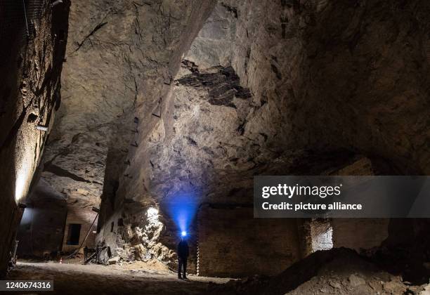 April 2022, North Rhine-Westphalia, Porta Westfalica: A man walks through a partially collapsed gallery in the Jakobsberg near Porta Westfalica. The...