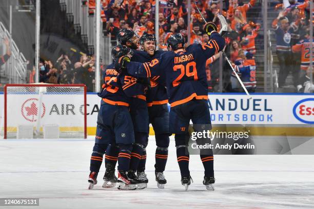 Connor McDavid, Darnell Nurse, Kailer Yamamoto and Leon Draisaitl of the Edmonton Oilers celebrate after a goal during Game Seven of the First Round...