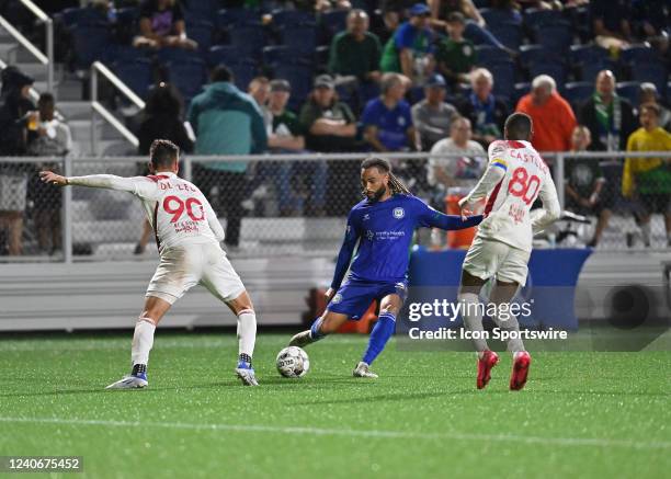 Hartford Athletic defender Joel Johnson passes the ball off between New York Red Bulls II midfielder Daniel De Leon and New York Red Bulls II...