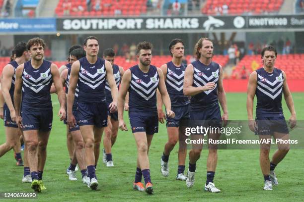 Dejected Fremantle side exit the field after the 2022 AFL Round 09 match between the Gold Coast Suns and the Fremantle Dockers at Metricon Stadium on...