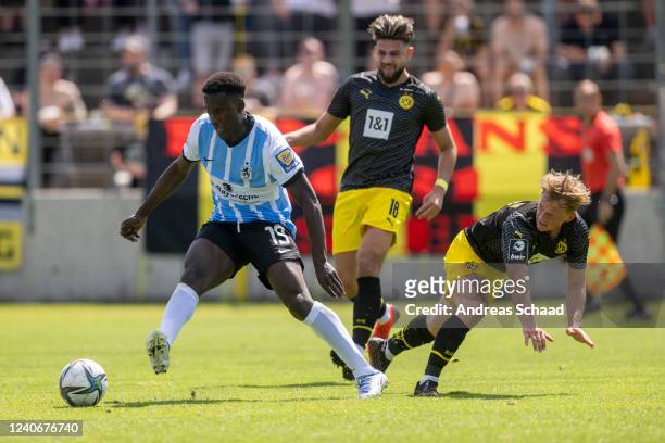 Antonios Papadopoulos and Lennard Maloney both of Borussia Dortmund II challenge for the ball with Merveille Biankadi of TSV 1860 Muenchen during the...